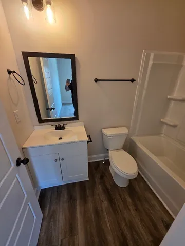 a bathroom with a toilet a sink and bathtub