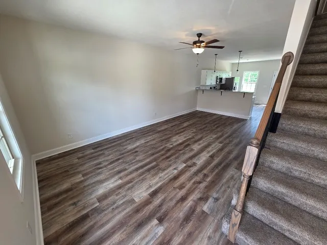 a view of entryway and hall with wooden floor