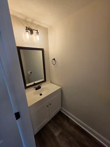 a room with a mirror and a wooden floor