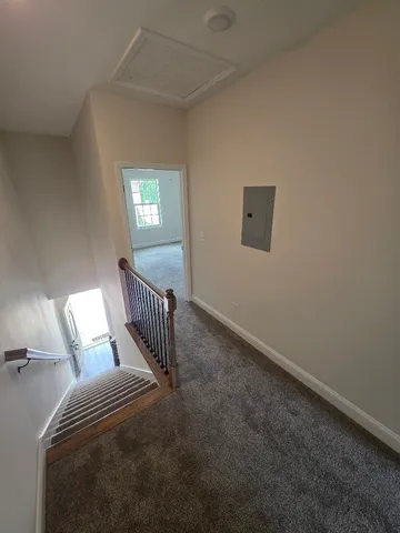 a view of an empty room and wooden floor