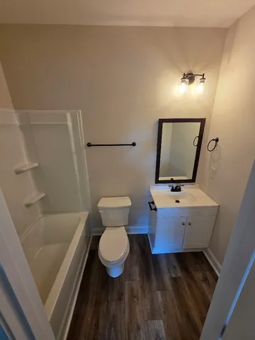 a bathroom with a toilet and a mirror