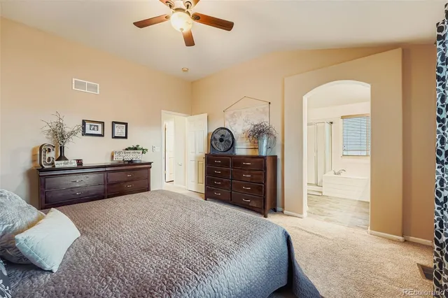 a bed room with a bed and a television