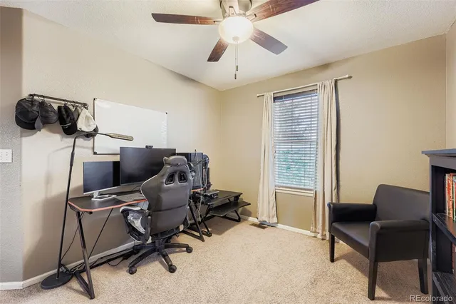 a view of a workspace with furniture and a window