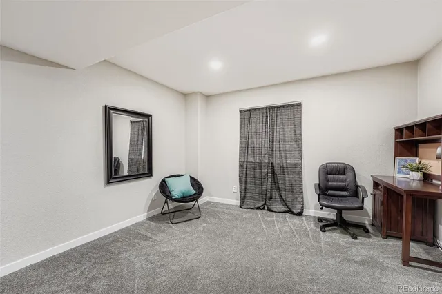 a view of a workspace with furniture and gym equipment
