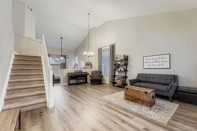 a living room with furniture and wooden floor