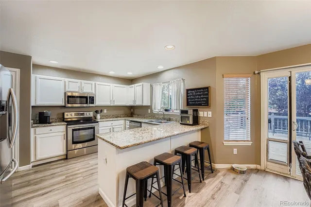 a kitchen with a stove a sink and a refrigerator