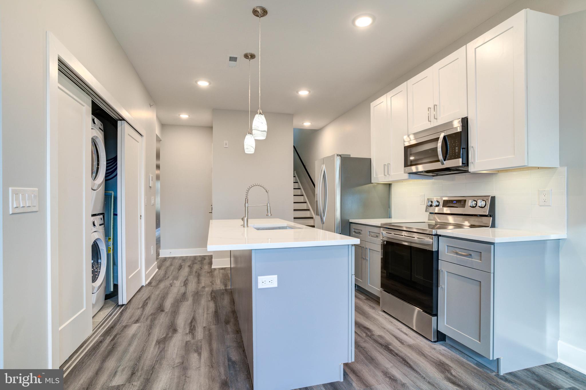 5005 Walnut Street Philadelphia, PA 19139 - Photo 25 of 39 a kitchen with stainless steel appliances granite countertop a stove and a sink