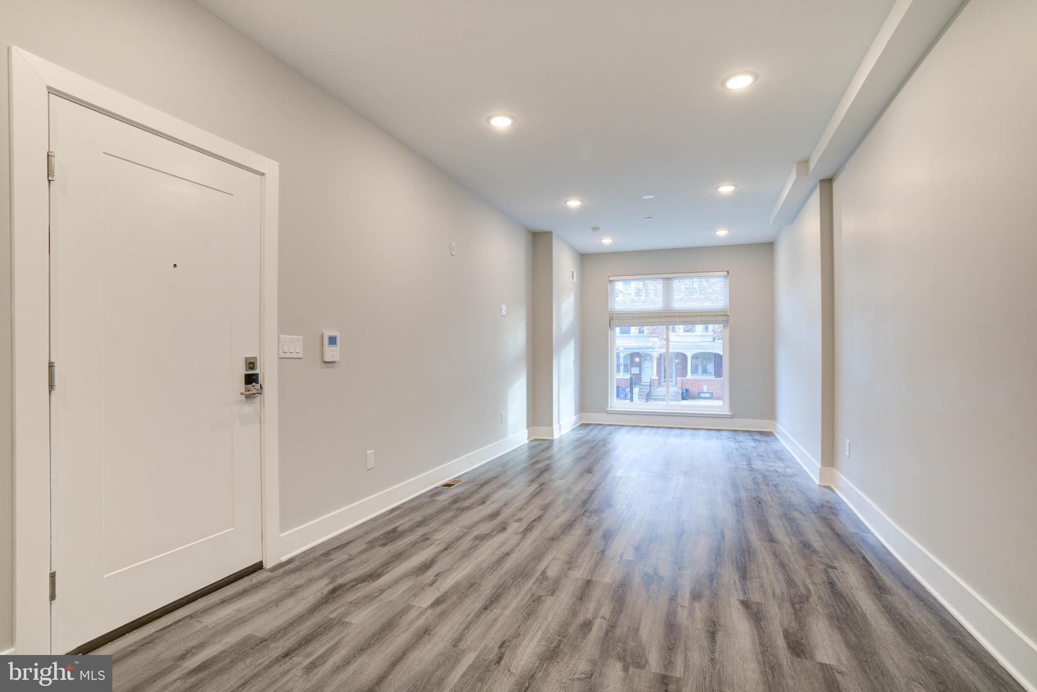 5005 Walnut Street Philadelphia, PA 19139 - Photo 3 of 39 a view of an empty room with wooden floor and a window