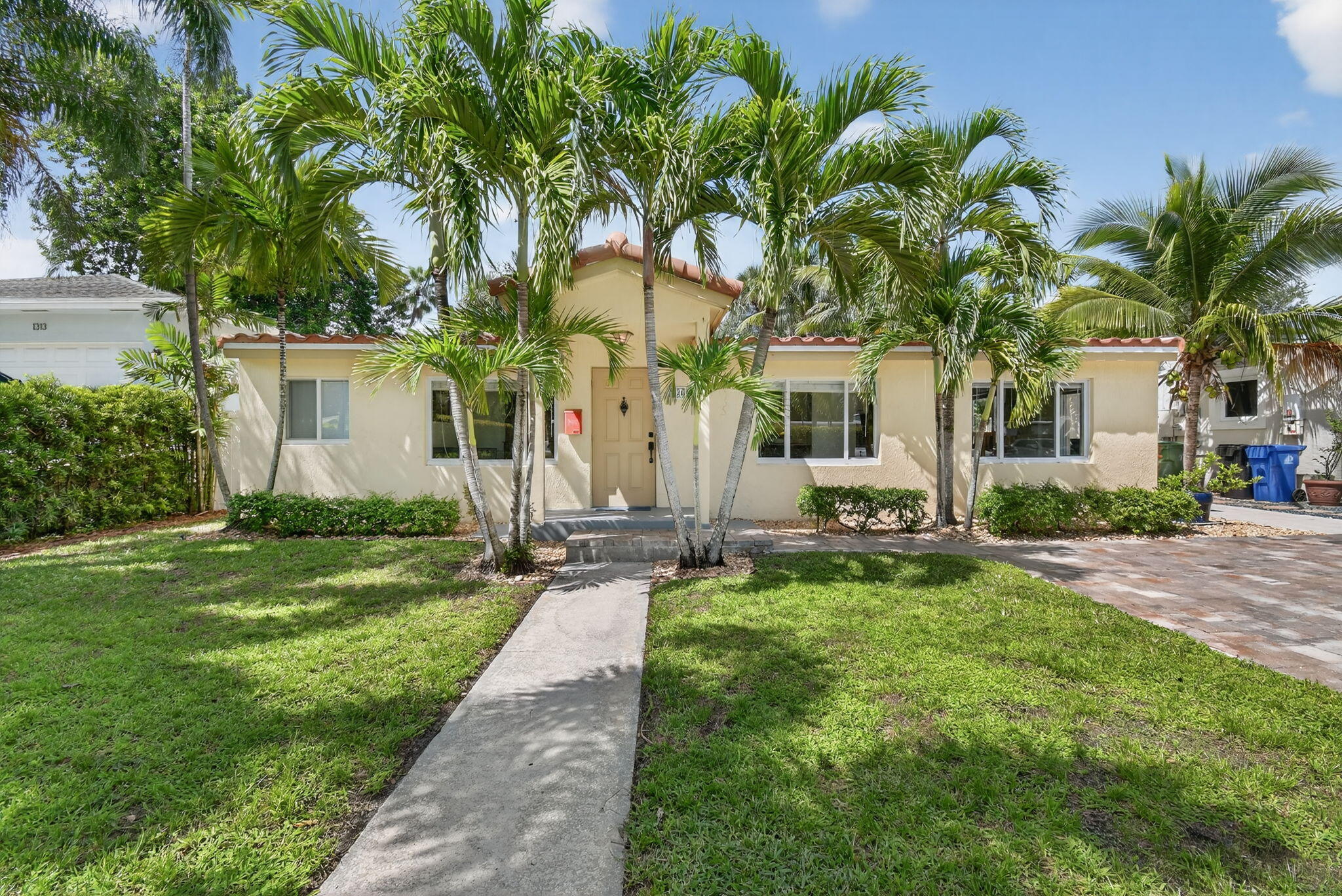 1309 Southwest 19th Avenue Fort Lauderdale, FL 33312 - Photo 1 of 66 a front view of a house with a yard and garage
