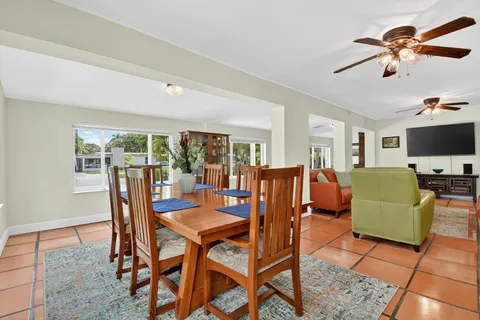 a kitchen with stainless steel appliances kitchen island granite countertop a dining table chairs and granite counter tops