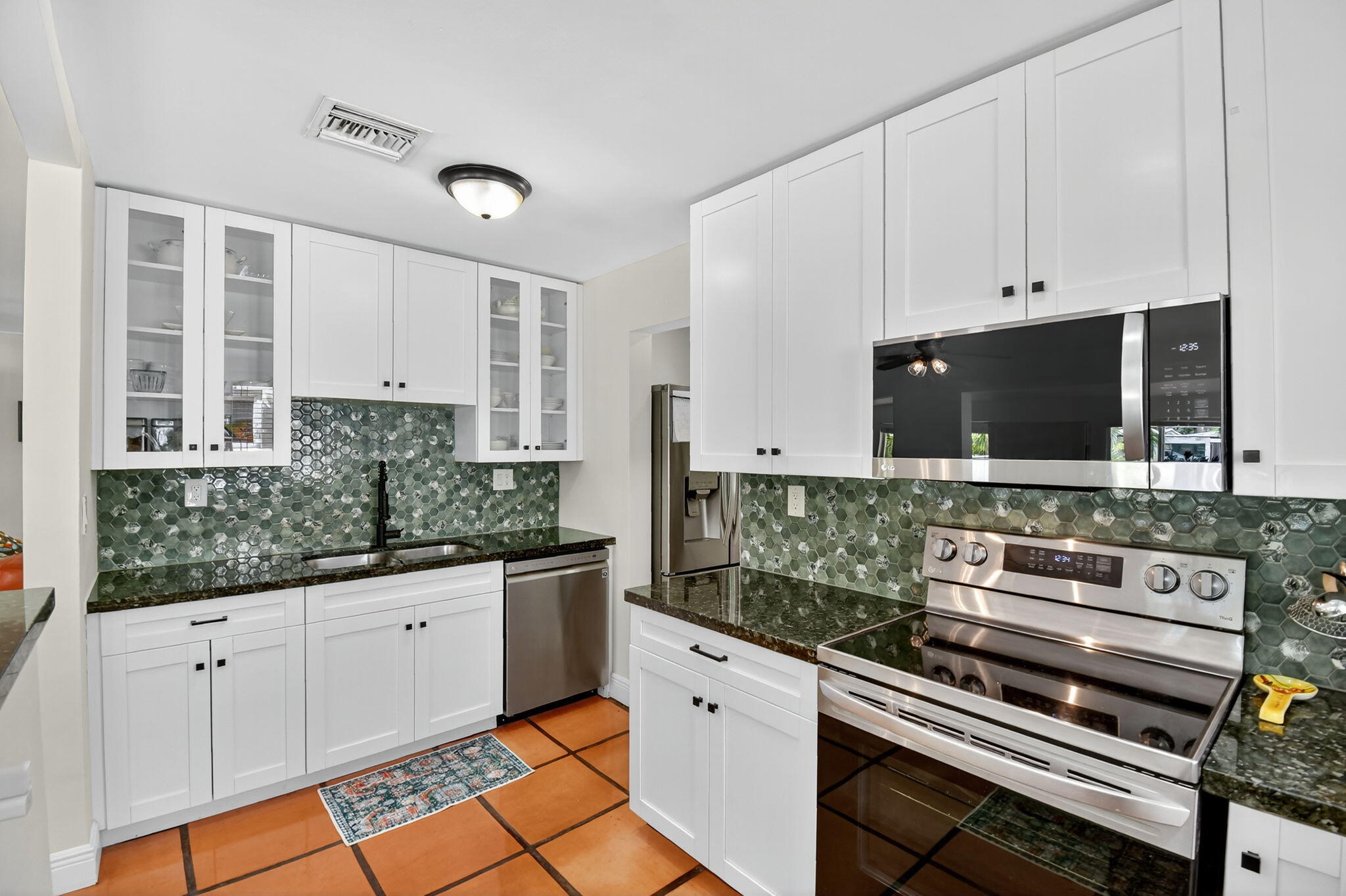 1309 Southwest 19th Avenue Fort Lauderdale, FL 33312 - Photo 18 of 66 a kitchen with stainless steel appliances kitchen island granite countertop a stove and a sink