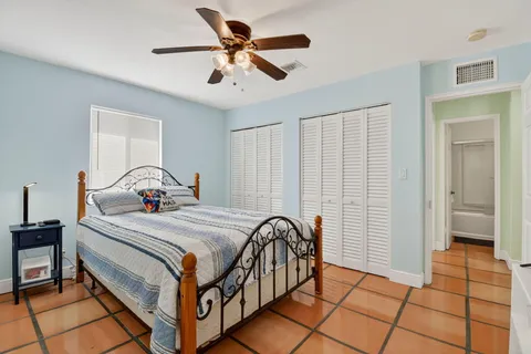a bedroom with a bed and a large window with the outer view