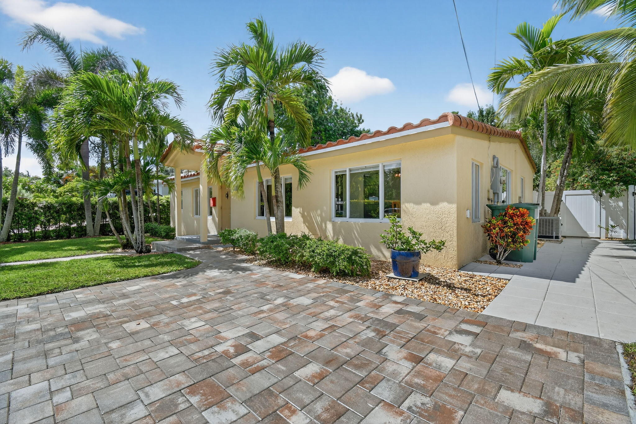 1309 Southwest 19th Avenue Fort Lauderdale, FL 33312 - Photo 3 of 66 a front view of a house with a yard and potted plants