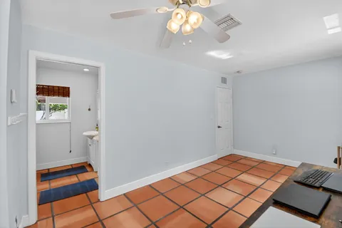 a view of a yard with plants and trees