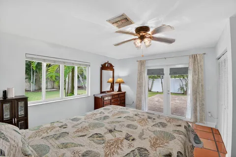 a view of a backyard with a garden and a tree