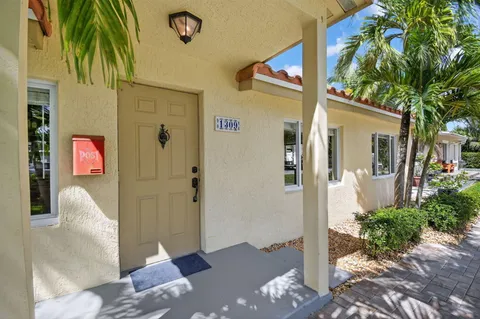 a front view of a house with a tree