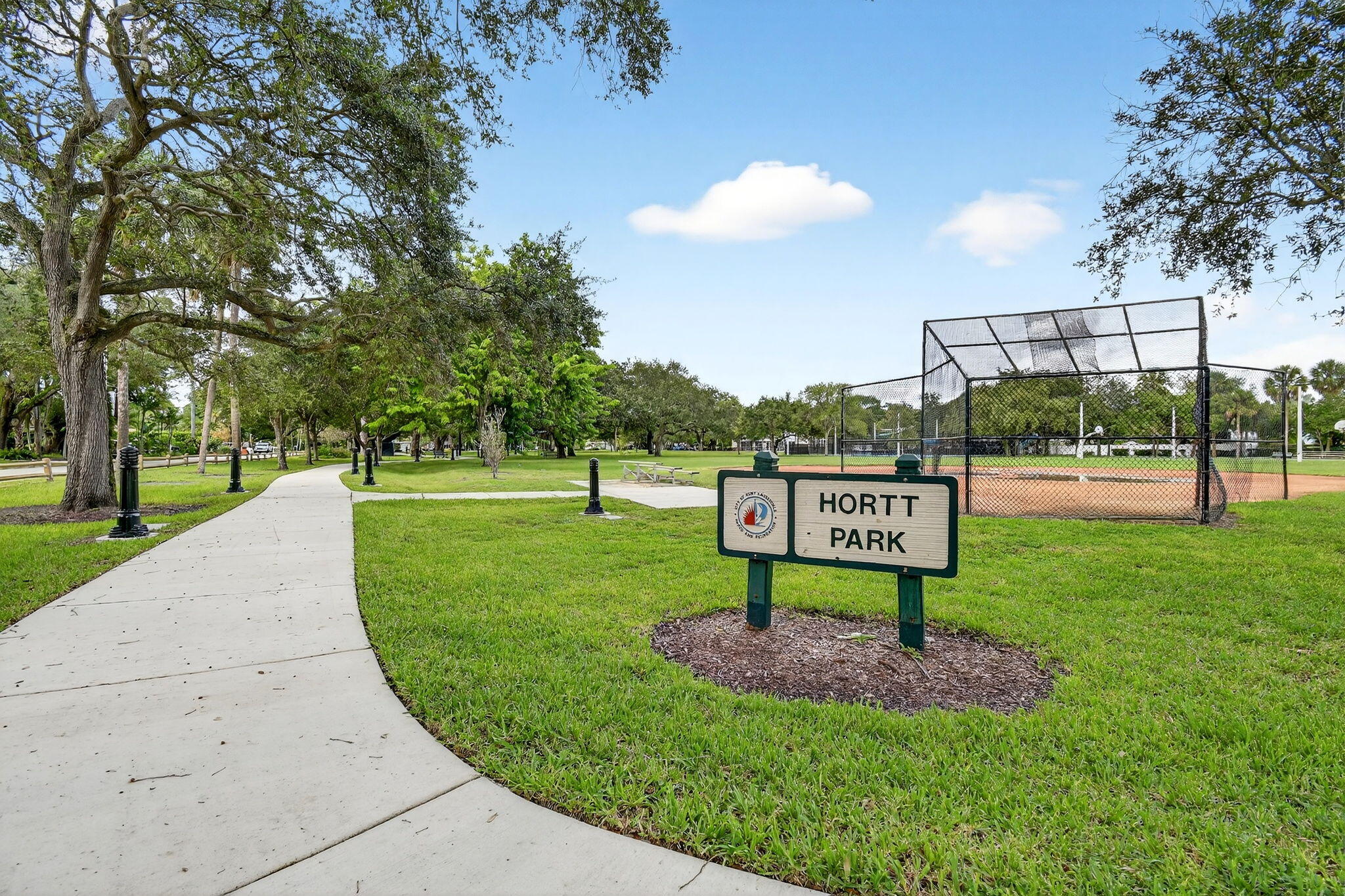 1309 Southwest 19th Avenue Fort Lauderdale, FL 33312 - Photo 61 of 66 a sign board with a play ground in the back