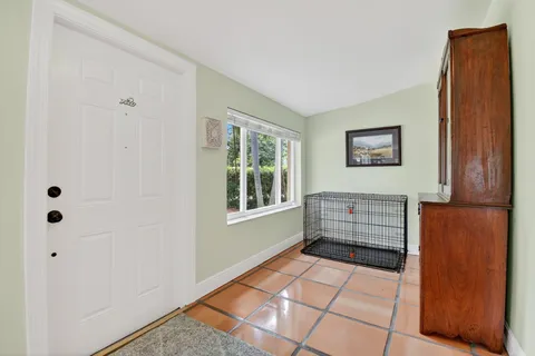 a living room with furniture a fireplace and a chandelier