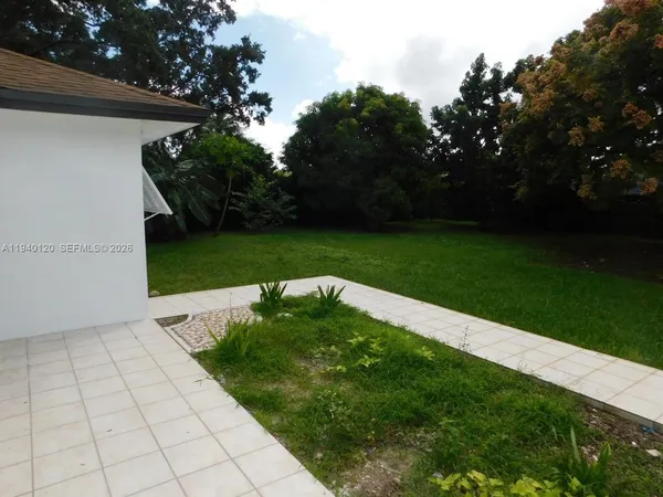 a view of a backyard with large trees