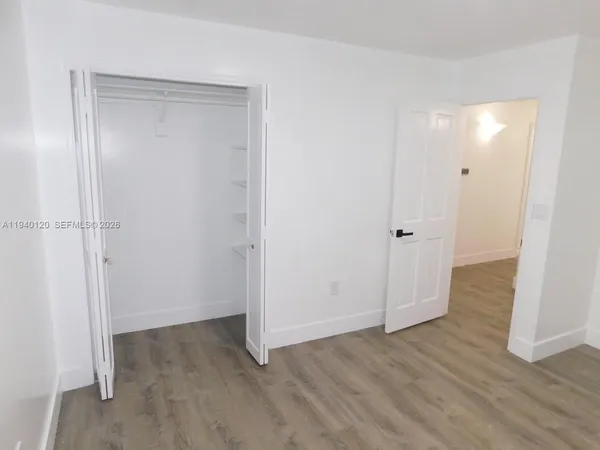 a view of a room with wooden floor