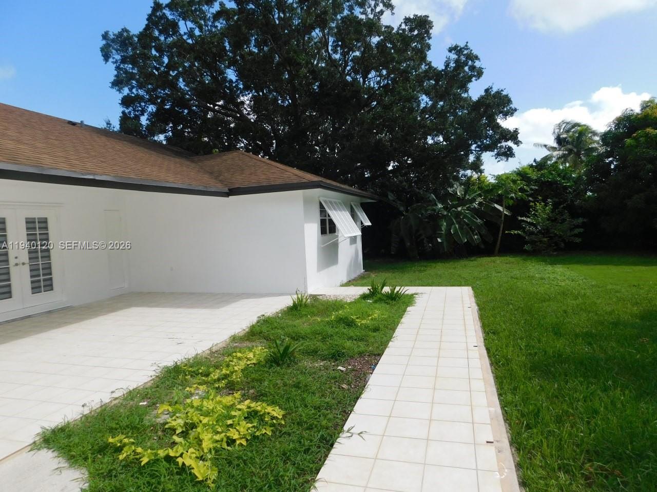 16240 Southwest 286th Street Homestead, FL 33033 - Photo 2 of 25 a front view of a house with garden