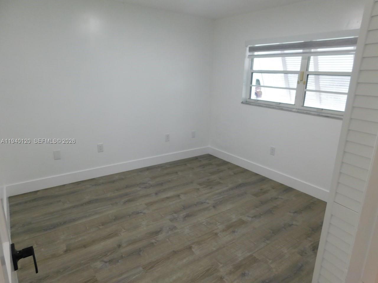 16240 Southwest 286th Street Homestead, FL 33033 - Photo 22 of 25 an empty room with wooden floor and windows