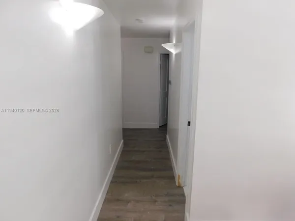a view of a hallway with the wooden floor