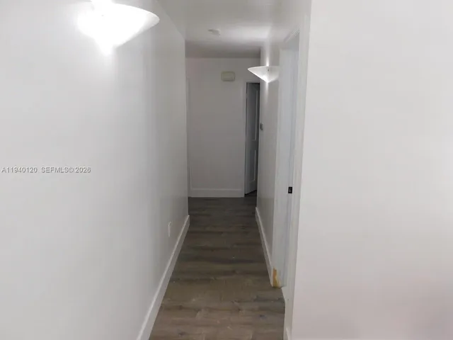 a view of a hallway with the wooden floor