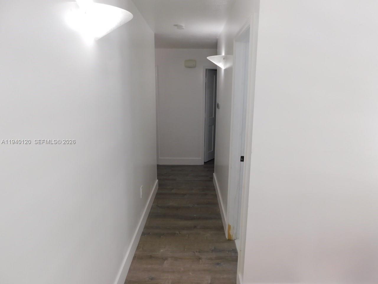 16240 Southwest 286th Street Homestead, FL 33033 - Photo 23 of 25 a view of a hallway with the wooden floor