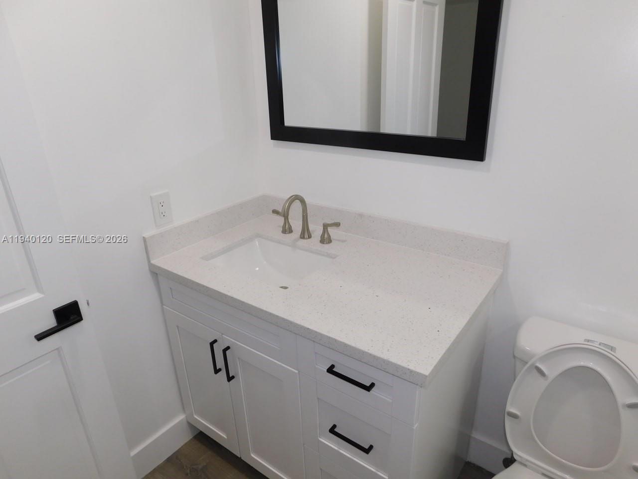 16240 Southwest 286th Street Homestead, FL 33033 - Photo 8 of 25 a bathroom with a sink a toilet and mirror