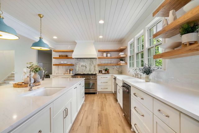 a kitchen with kitchen island granite countertop lots of counter top space and sink