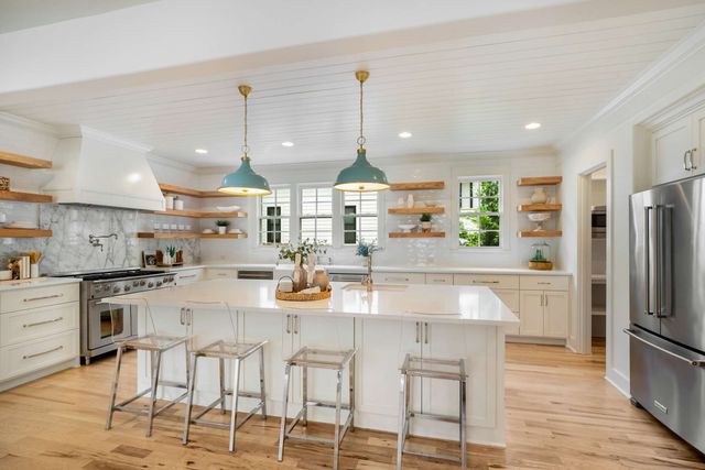 a living room with furniture a table and a large window