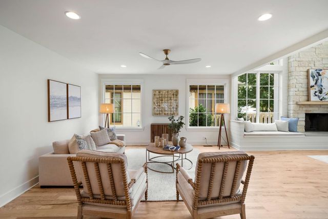 a living room with furniture large window and fireplace