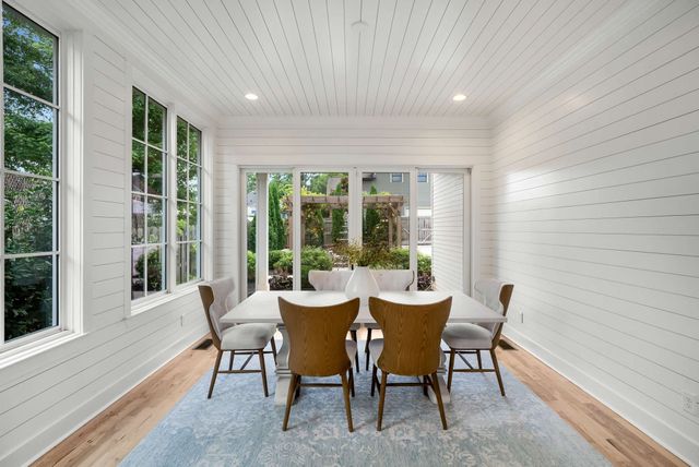 a bathroom with a granite countertop toilet a sink a mirror a bathtub and shower