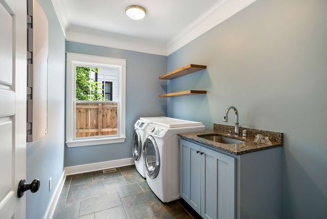 a spacious bathroom with a double vanity sink a mirror and a bathtub