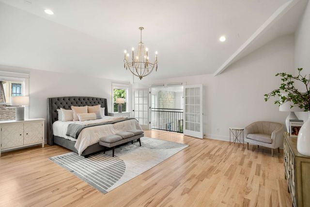 a spacious bathroom with a granite countertop sink and a mirror
