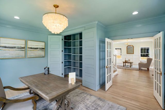 a kitchen with stainless steel appliances kitchen island granite countertop a kitchen island and chairs in it