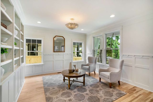 a large white kitchen with a large counter top appliances and cabinets