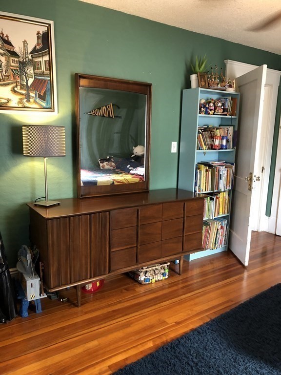 24 Daviston Street Springfield, MA 01108 - Photo 20 of 38 a room with lots of wooden furniture and a potted plant