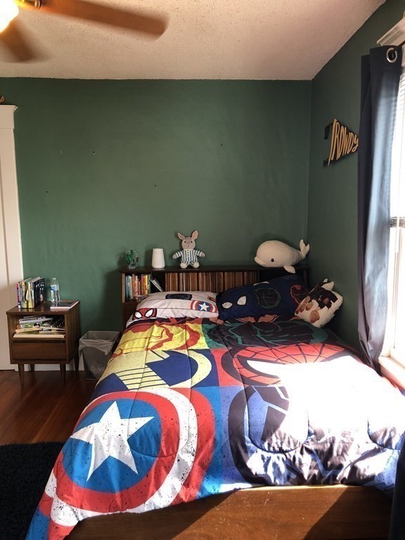 24 Daviston Street Springfield, MA 01108 - Photo 21 of 38 a bedroom with a bed and a table