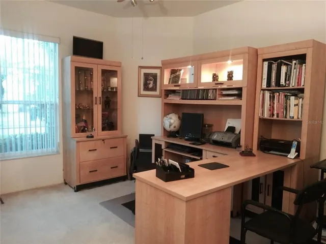 a bedroom with a bed and a large mirror