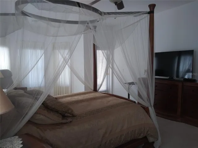a white toilet sitting next to a white wall
