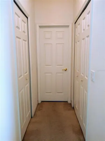 a kitchen with stainless steel appliances granite countertop a sink a refrigerator and wooden cabinets