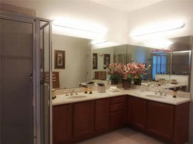 a kitchen with granite countertop a refrigerator stove and sink