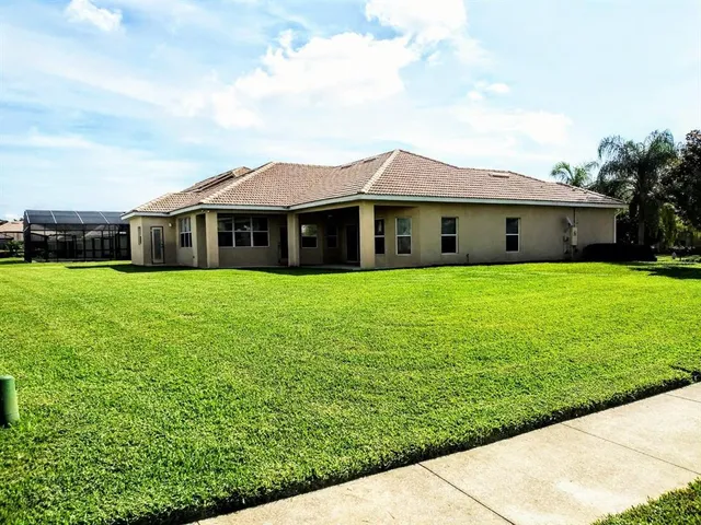 a view of a house with a garden and yard