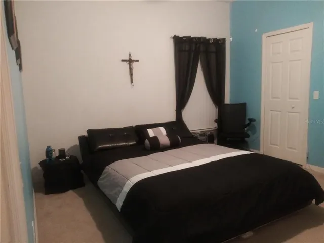 an aerial view of residential houses with outdoor space and parking