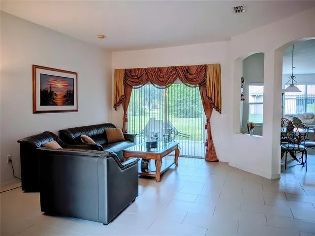 a living room with furniture and a lamp