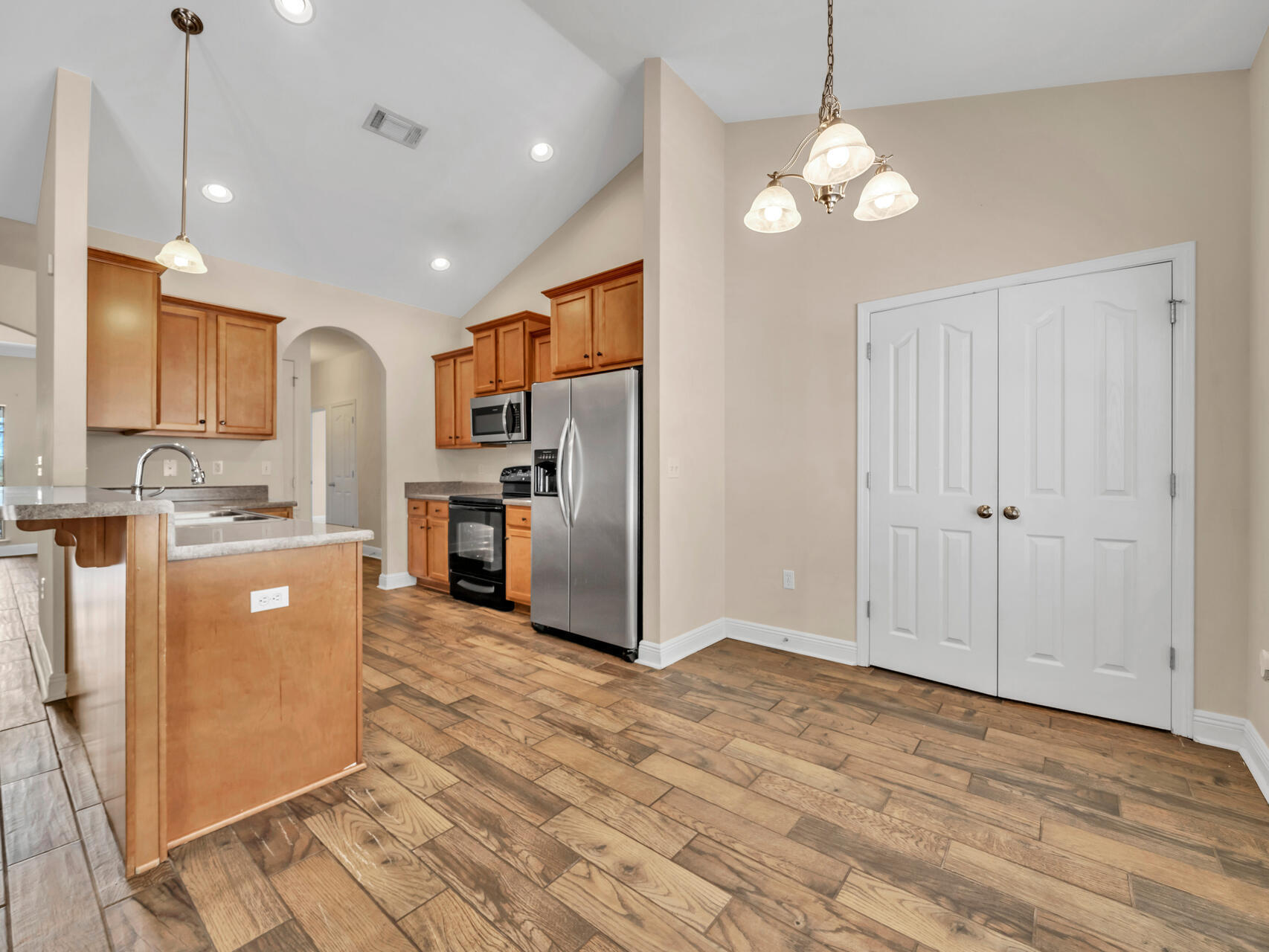 612 Rowan Circle Crestview, FL 32536 - Photo 11 of 32 a large kitchen with granite countertop a stove a sink a refrigerator and cabinets