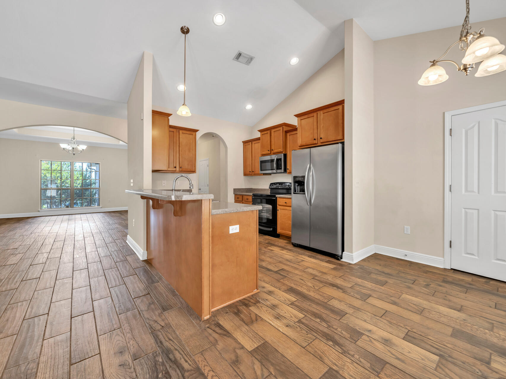 612 Rowan Circle Crestview, FL 32536 - Photo 14 of 32 a kitchen with stainless steel appliances granite countertop a refrigerator a oven a sink and a wooden floors