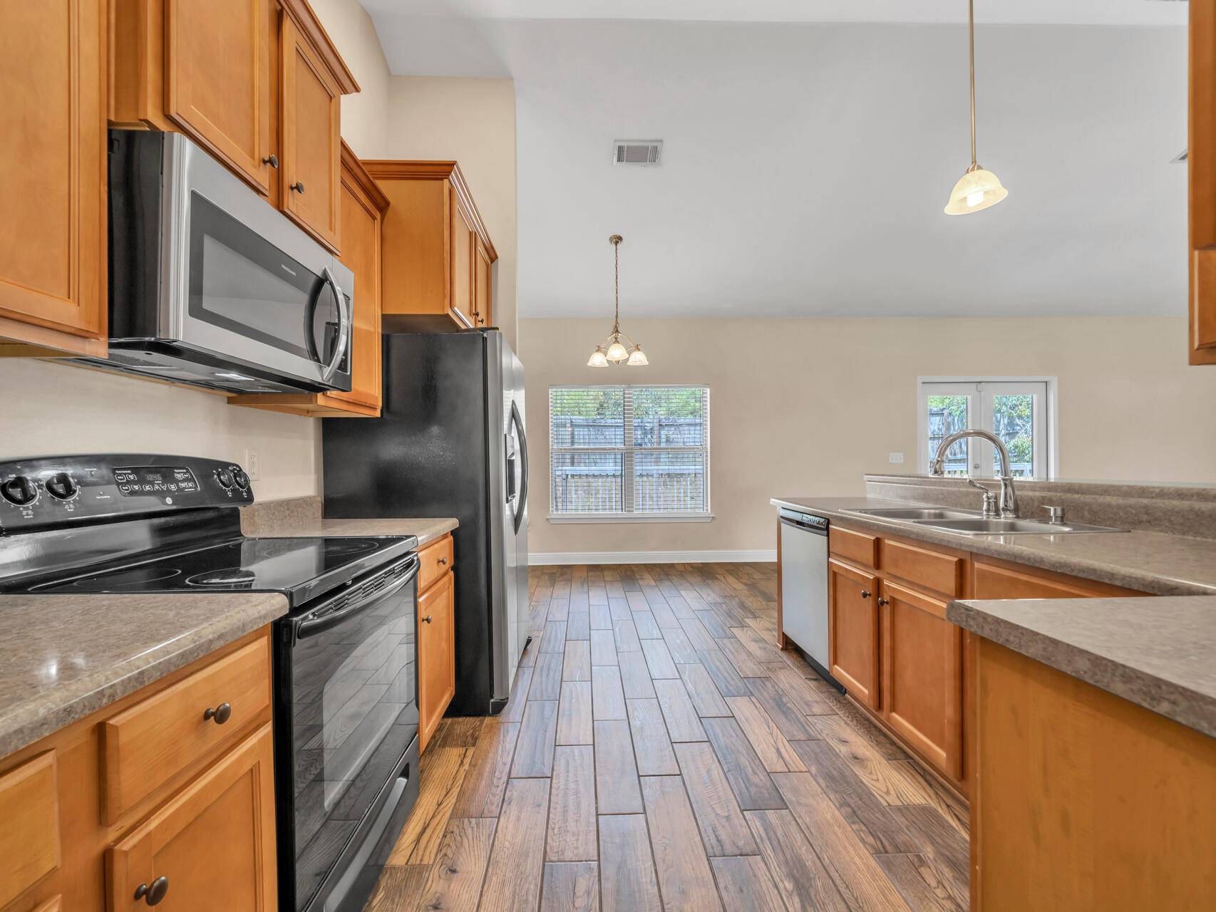 612 Rowan Circle Crestview, FL 32536 - Photo 15 of 32 a kitchen with stainless steel appliances granite countertop a stove a sink and a microwave